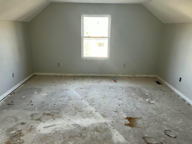 additional living space featuring lofted ceiling