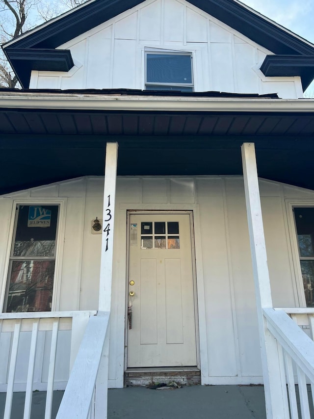 view of exterior entry with a porch