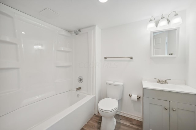 full bathroom featuring hardwood / wood-style floors, vanity, toilet, and shower / bathing tub combination