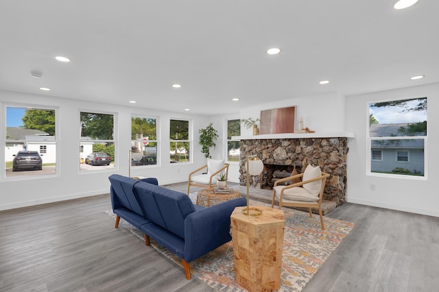 living room with light wood-type flooring and a fireplace