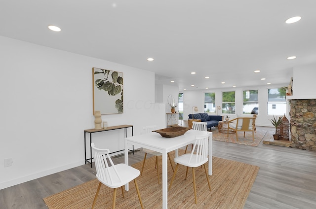 dining room featuring a fireplace and light wood-type flooring