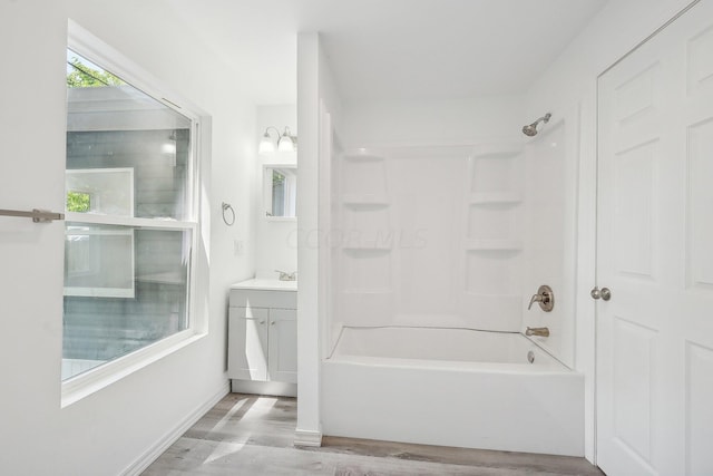 bathroom with shower / washtub combination, vanity, and hardwood / wood-style flooring