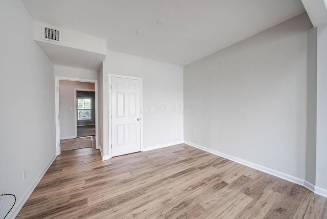 unfurnished room with light hardwood / wood-style floors