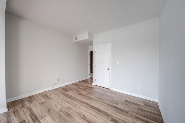 unfurnished room with light hardwood / wood-style flooring