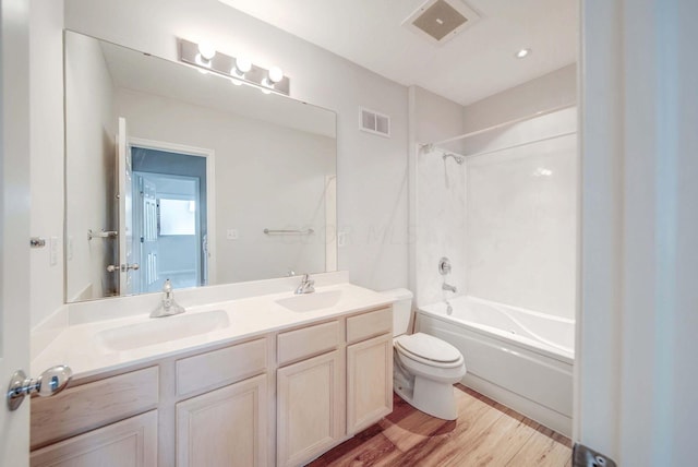 full bathroom featuring shower / bathing tub combination, toilet, vanity, and hardwood / wood-style flooring