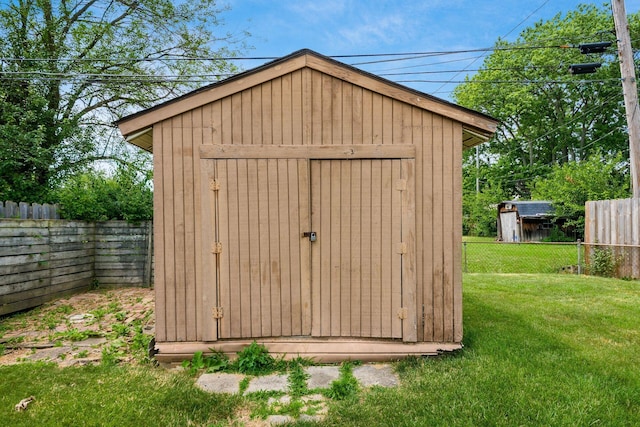 view of outbuilding with a lawn