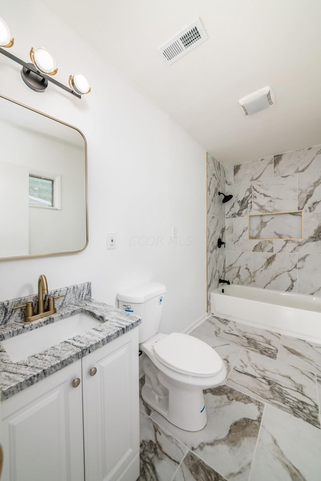 full bathroom featuring toilet, vanity, and tiled shower / bath