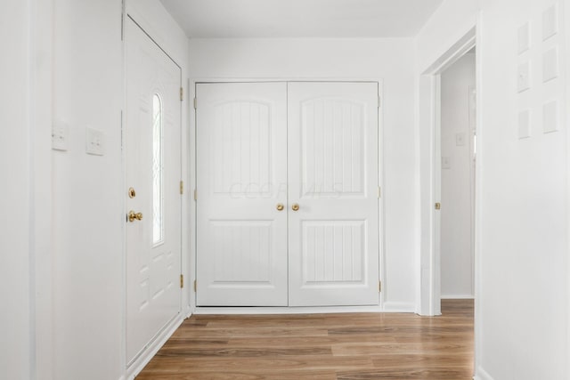 hallway with wood-type flooring