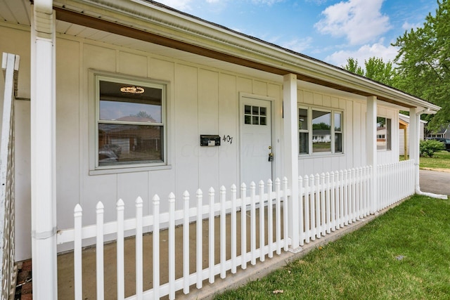 view of exterior entry featuring a porch