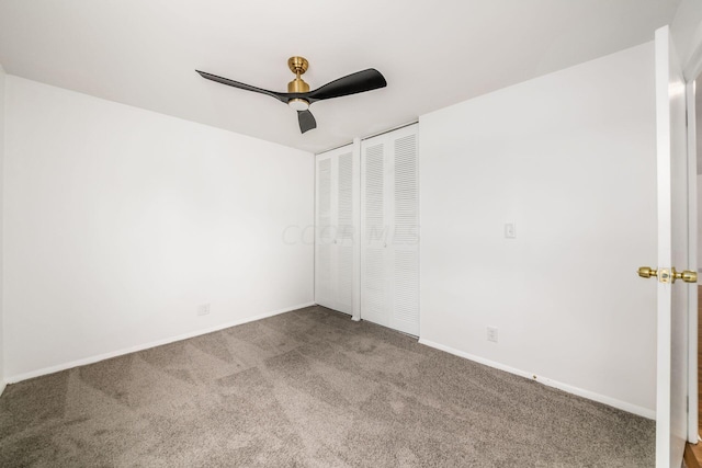 carpeted empty room featuring ceiling fan