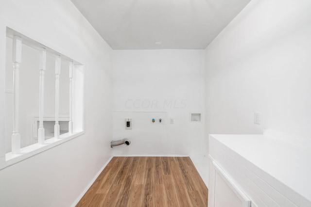 clothes washing area with hookup for an electric dryer, gas dryer hookup, wood-type flooring, and hookup for a washing machine