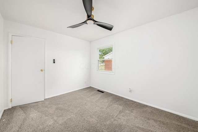 carpeted spare room featuring ceiling fan