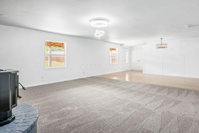 living room with a wood stove and hardwood / wood-style floors