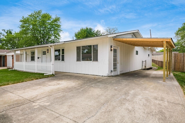 view of front of home with a porch and a carport