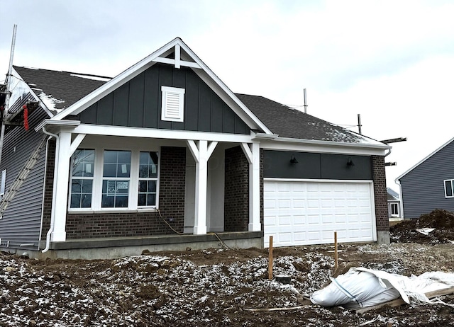 view of front of house featuring board and batten siding, brick siding, and a porch