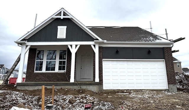 view of front of property featuring board and batten siding, covered porch, and brick siding