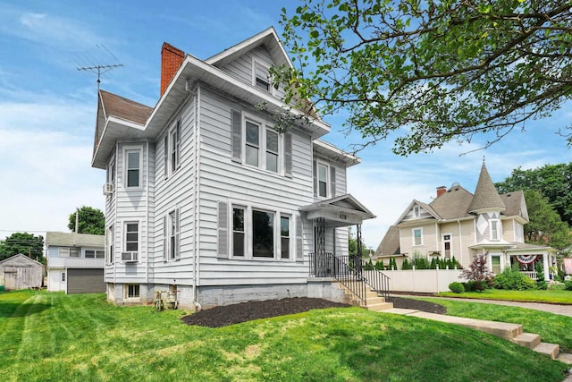 view of front facade with cooling unit and a front yard