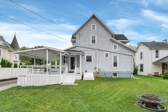 back of property featuring a yard and a deck