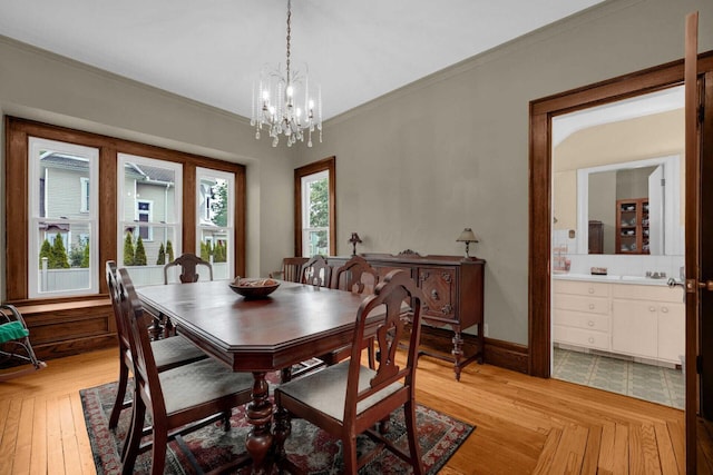 dining room with an inviting chandelier and crown molding