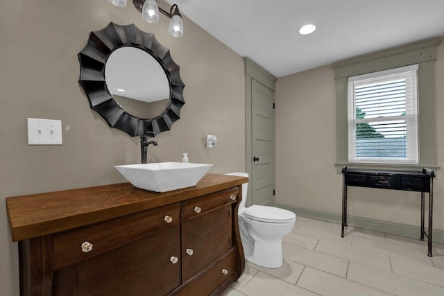 bathroom featuring tile patterned flooring, vanity, and toilet