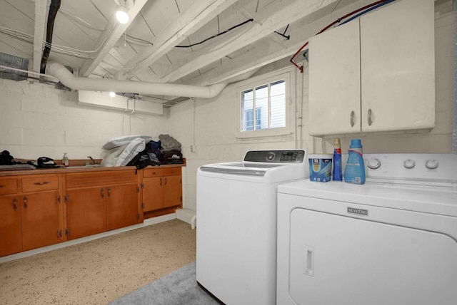 laundry area featuring cabinets and washing machine and dryer