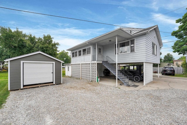 view of front facade with a carport, an outbuilding, and covered porch