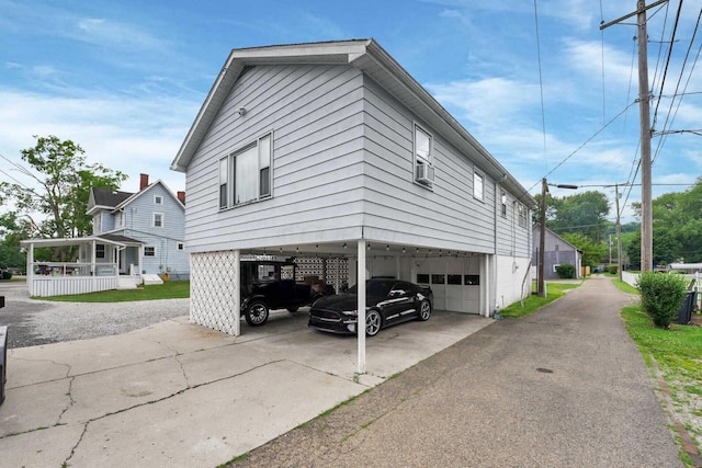 view of property exterior with a garage and a carport