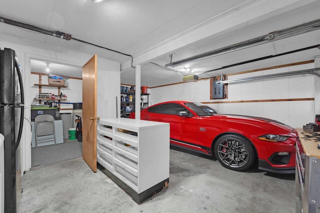 garage with black refrigerator and electric panel