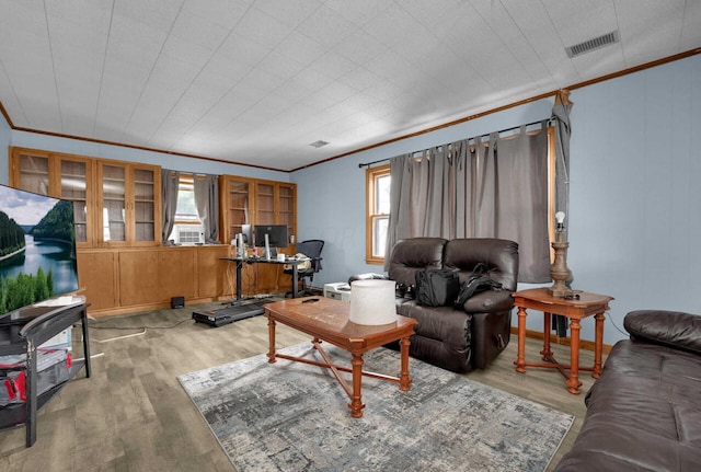 living room featuring ornamental molding and light hardwood / wood-style flooring