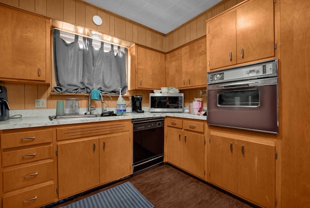 kitchen featuring black appliances, crown molding, dark hardwood / wood-style flooring, and sink