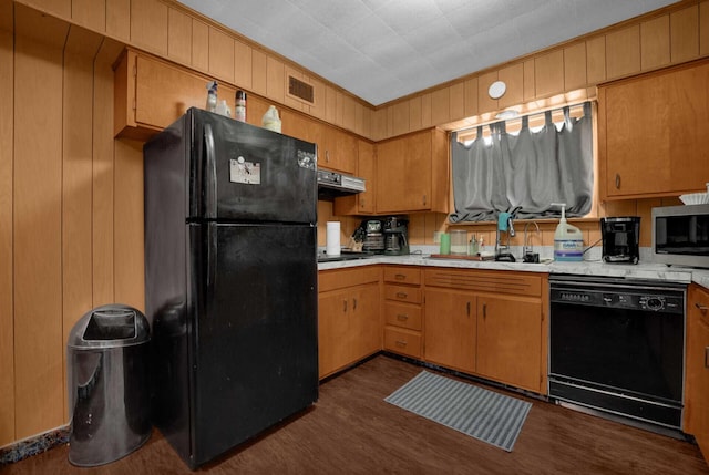 kitchen with black appliances, ventilation hood, sink, ornamental molding, and dark hardwood / wood-style flooring