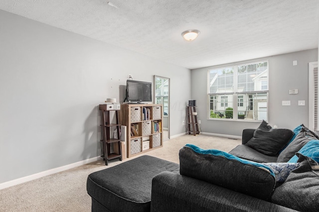 carpeted living room featuring a textured ceiling