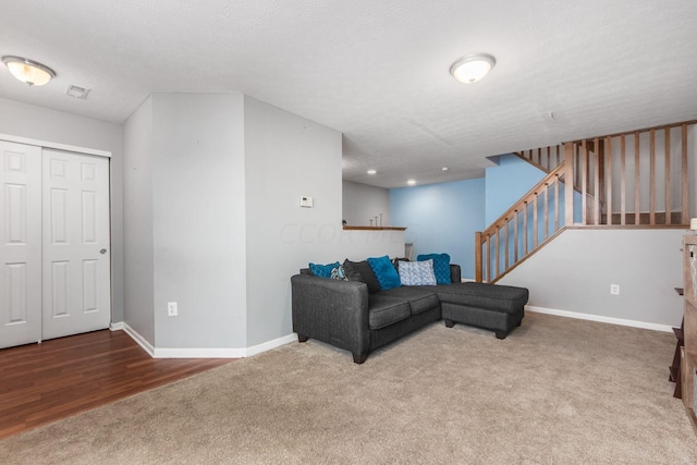 living room with a textured ceiling and carpet floors