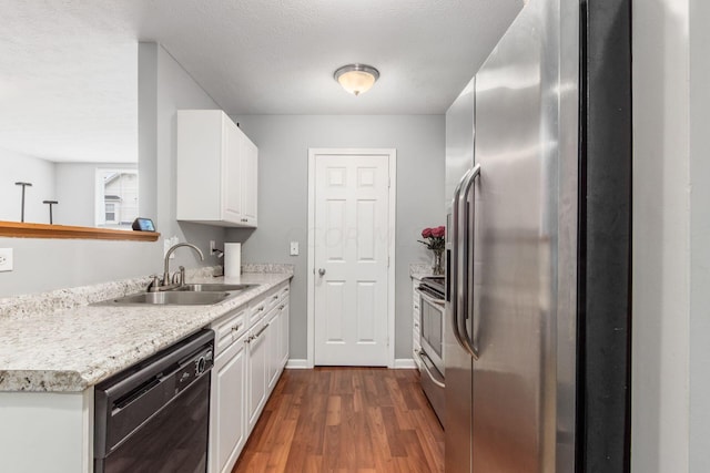 kitchen featuring dark wood-type flooring, sink, a textured ceiling, white cabinetry, and stainless steel appliances