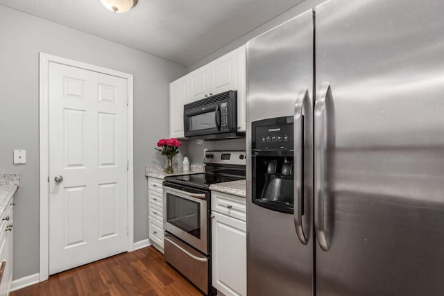 kitchen featuring light stone counters, white cabinets, stainless steel appliances, and dark hardwood / wood-style floors