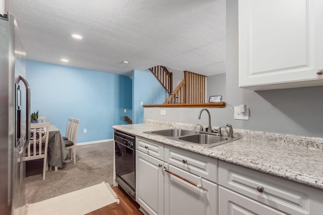 kitchen with white cabinetry, dishwasher, sink, and a textured ceiling