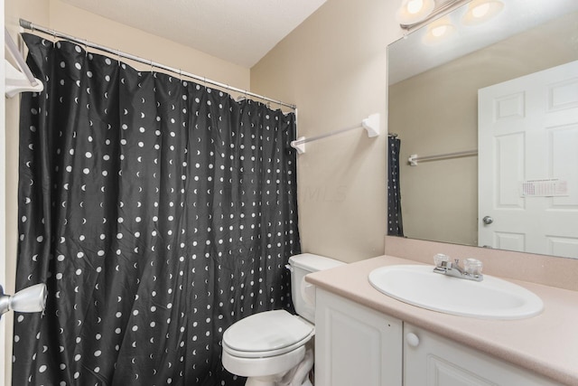 bathroom with vanity, a shower with shower curtain, and toilet