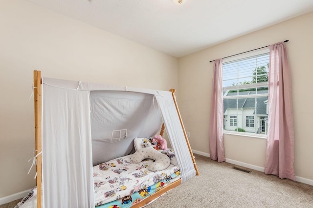 bedroom featuring light colored carpet