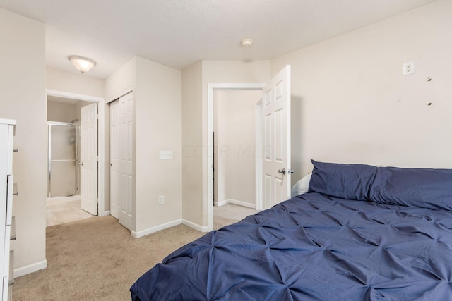 bedroom featuring light colored carpet and a closet