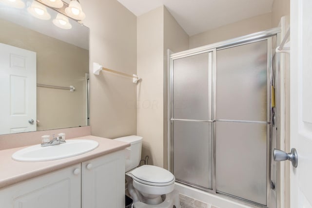 bathroom with vanity, toilet, and walk in shower