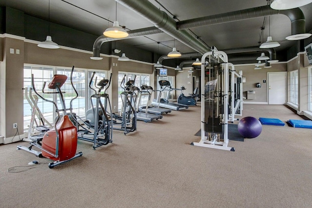 workout area featuring a towering ceiling