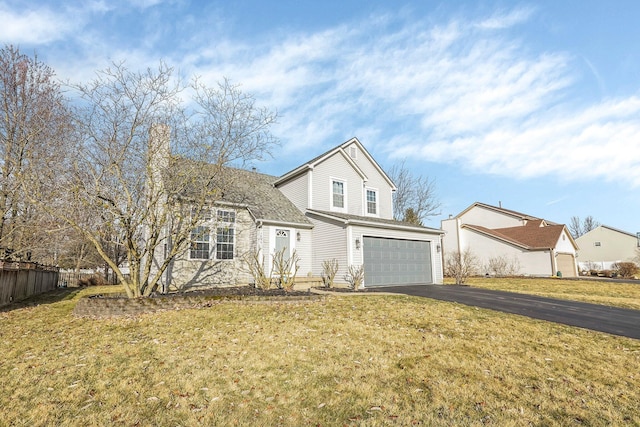 view of front property featuring a garage and a front yard