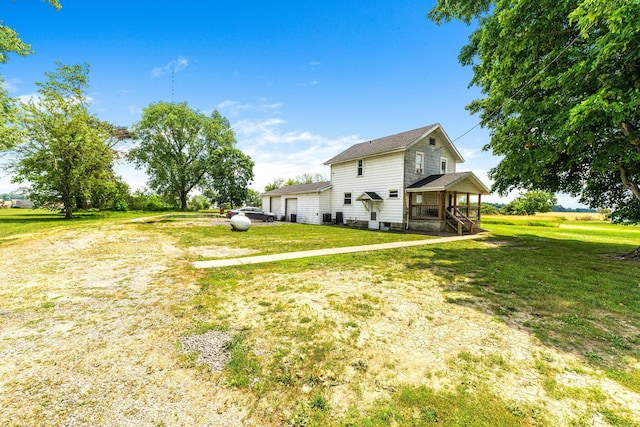 view of home's exterior featuring a porch and a lawn