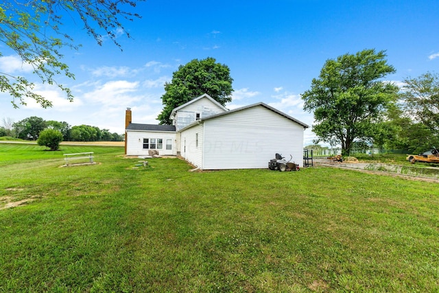 back of property featuring a lawn