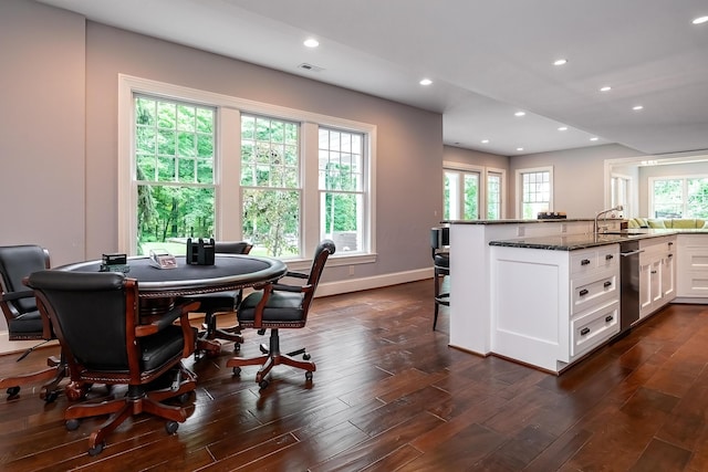 dining space with dark hardwood / wood-style floors and sink