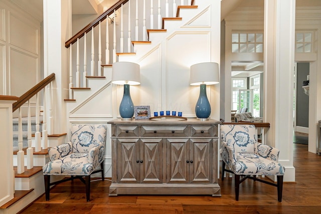 stairs with ornamental molding and hardwood / wood-style flooring