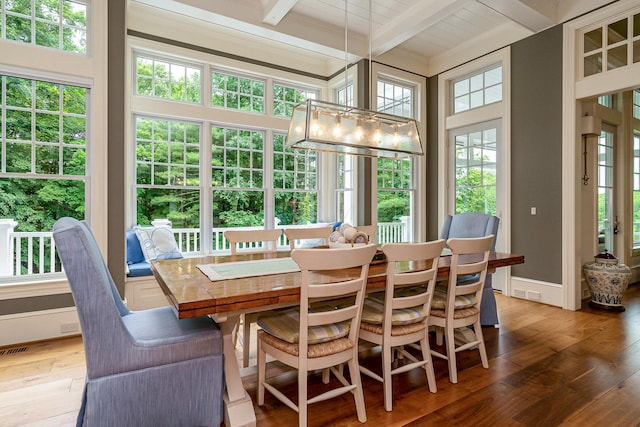 sunroom with beamed ceiling, plenty of natural light, and wood ceiling