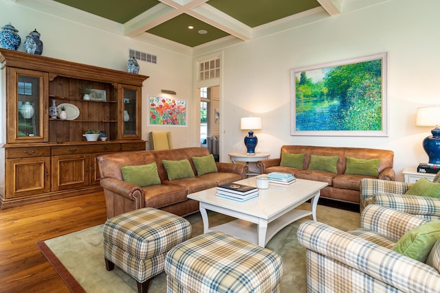 living room with beam ceiling, hardwood / wood-style floors, and coffered ceiling