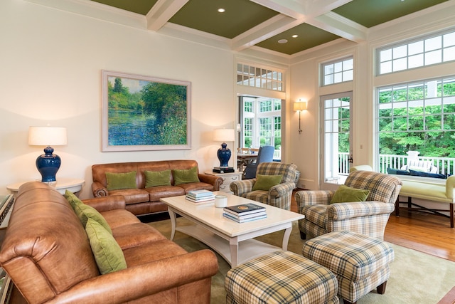 living room featuring beam ceiling, crown molding, coffered ceiling, and light wood-type flooring