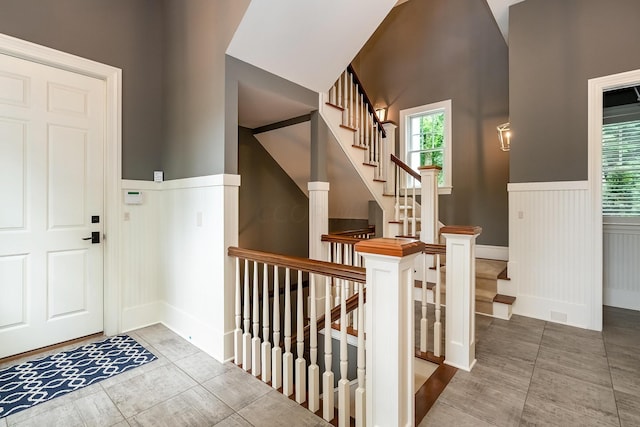 tiled foyer entrance with a wealth of natural light